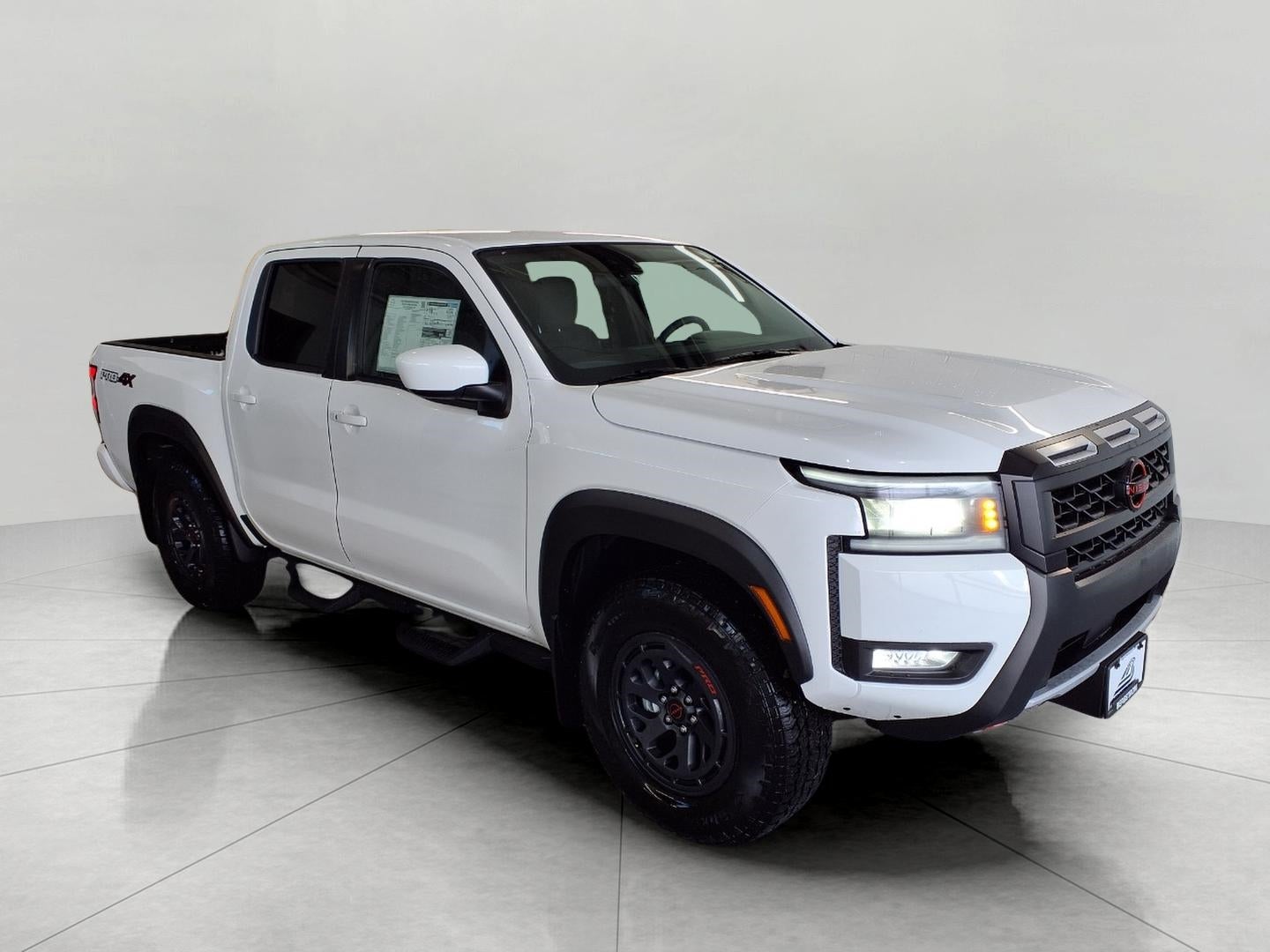 2026 Nissan Frontier Crew Cab 4x4 PRO-4X in Glacier White — front three-quarter view