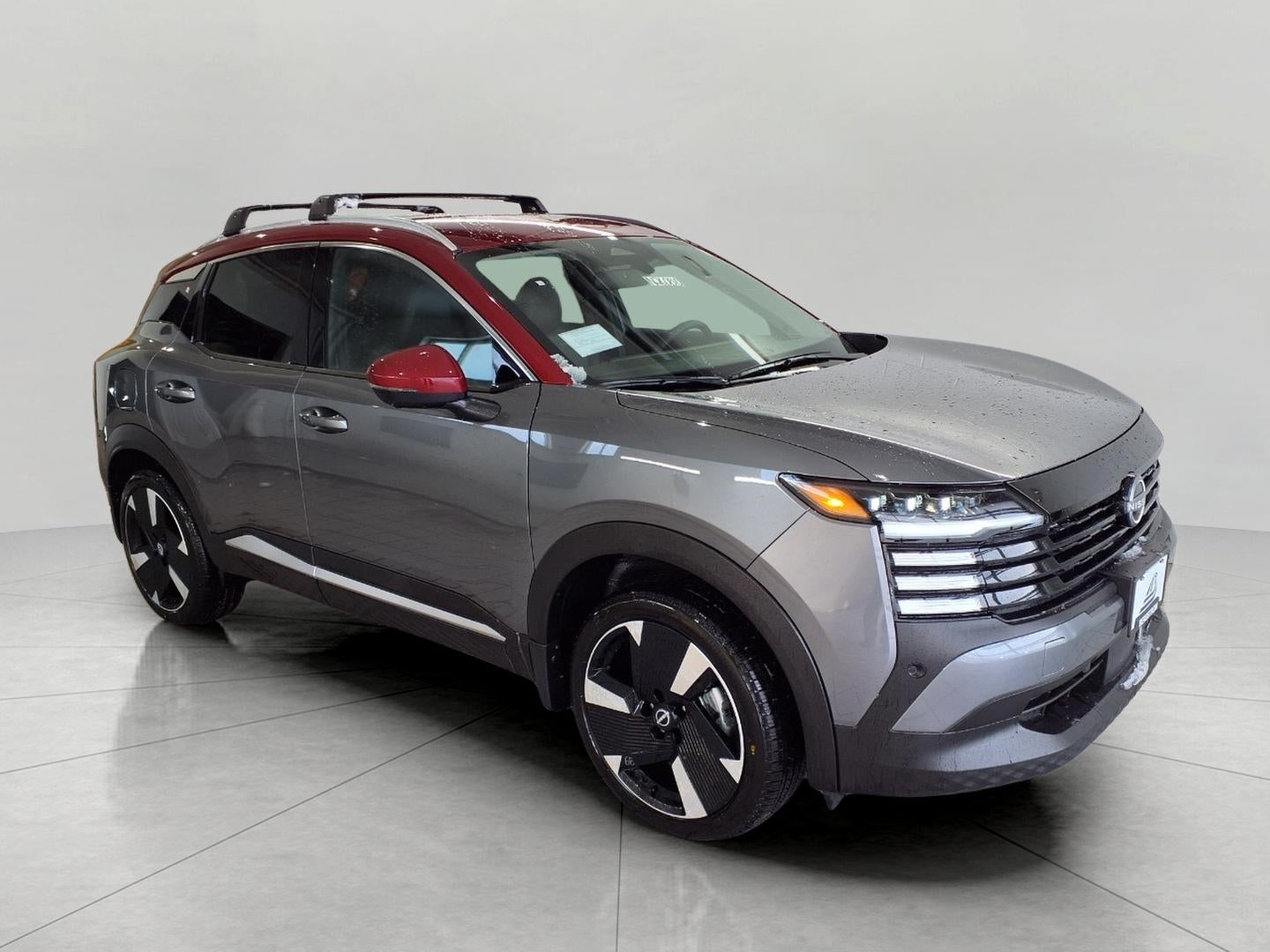2026 Nissan Kicks SR AWD in Gun Metallic Scarlet Ember Tintcoat Two Tone — front three-quarter view